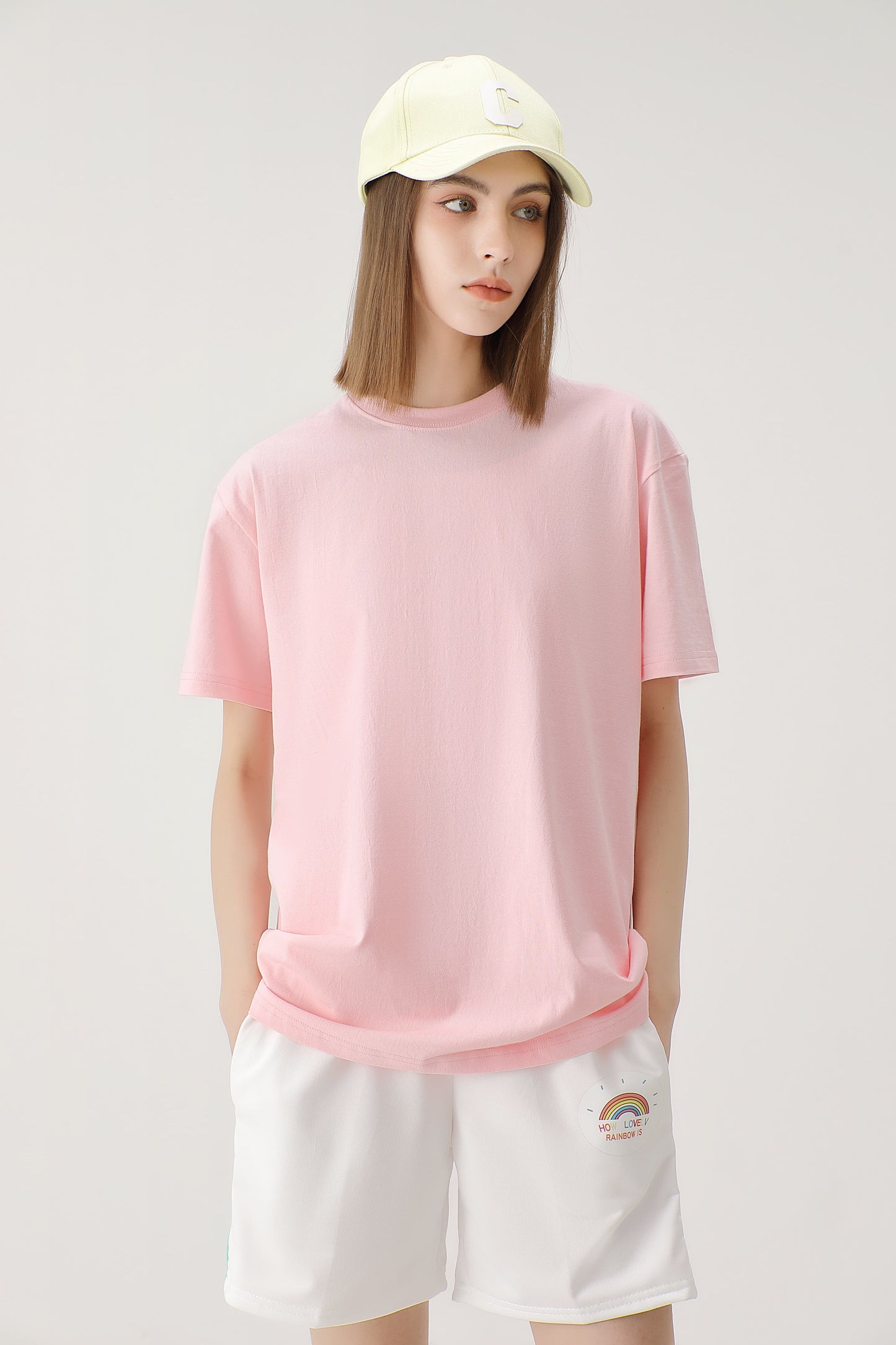 Female model wearing a soft pink 100% cotton t-shirt showing the relaxed fit and versatile style