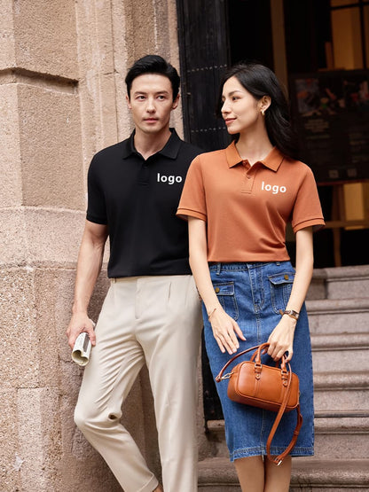Men’s black and women’s orange polo shirts featuring custom embroidered logos, ideal for promotional or staff apparel.