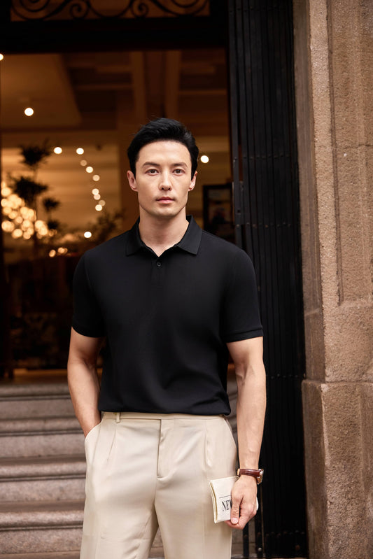 Male model wearing a classic black polo shirt showing the perfect casual-to-business fit